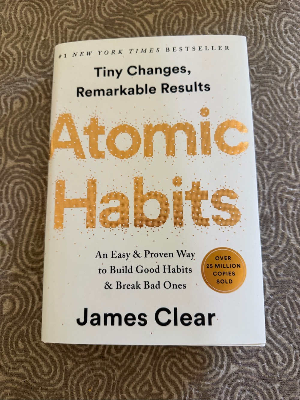 Atomic Habits by James Clear — White & Gold Paperback